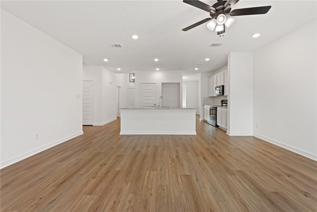 2426 Rooke Road Bryan, TX 77807 - Photo 17 of 39 a view of a kitchen with a dishwasher and wooden floor