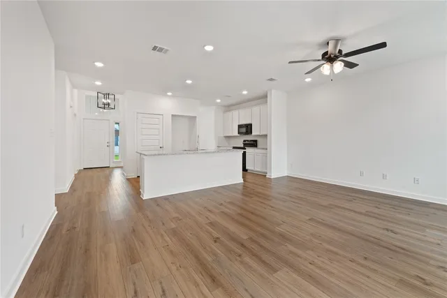 a view of a kitchen with a sink and a refrigerator