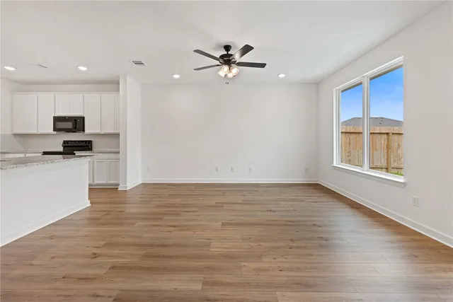 a view of a kitchen with a stove cabinets and wooden floor
