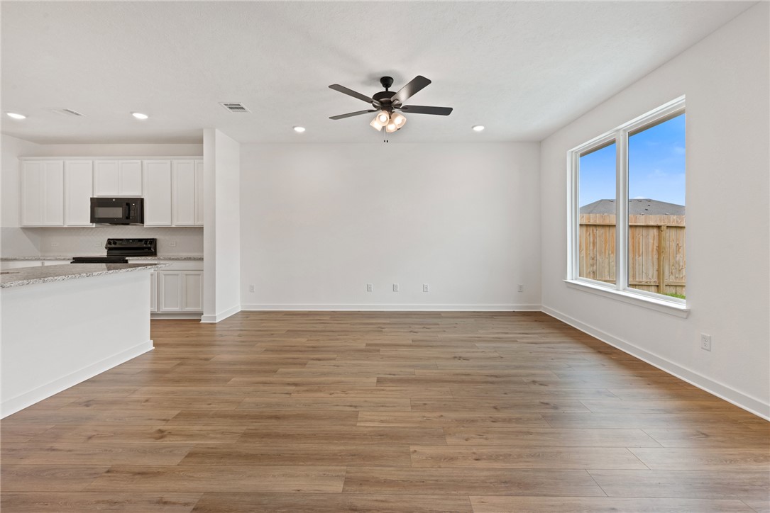 2426 Rooke Road Bryan, TX 77807 - Photo 19 of 39 a view of a kitchen with a stove cabinets and wooden floor