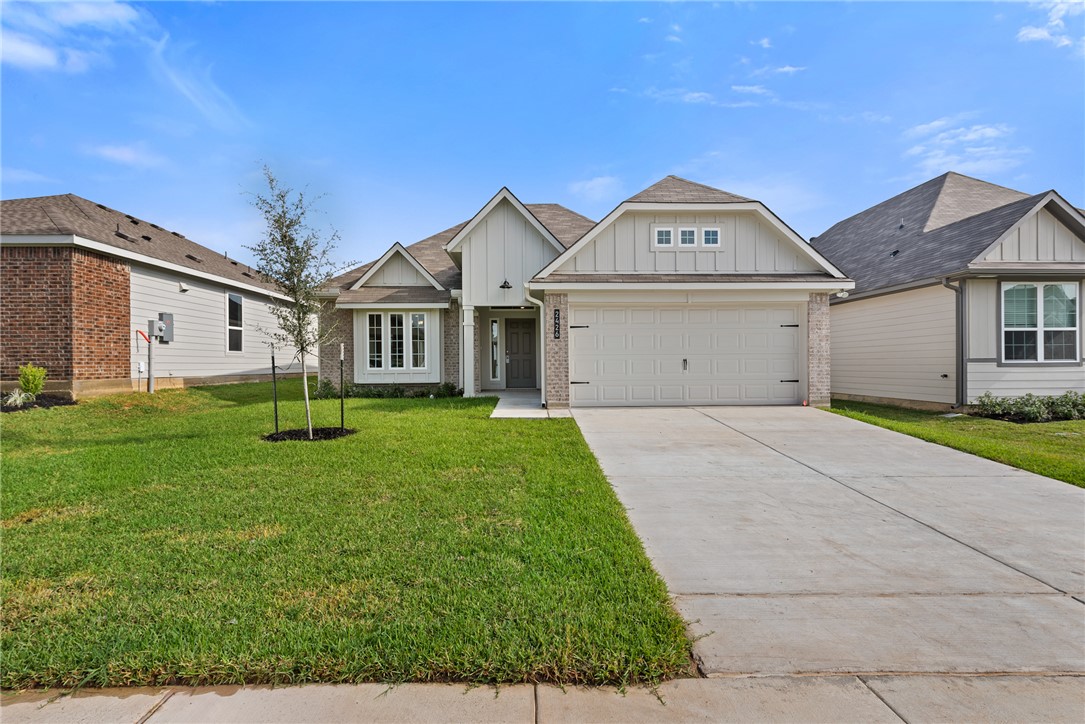 2426 Rooke Road Bryan, TX 77807 - Photo 2 of 39 a front view of a house with a yard and garage