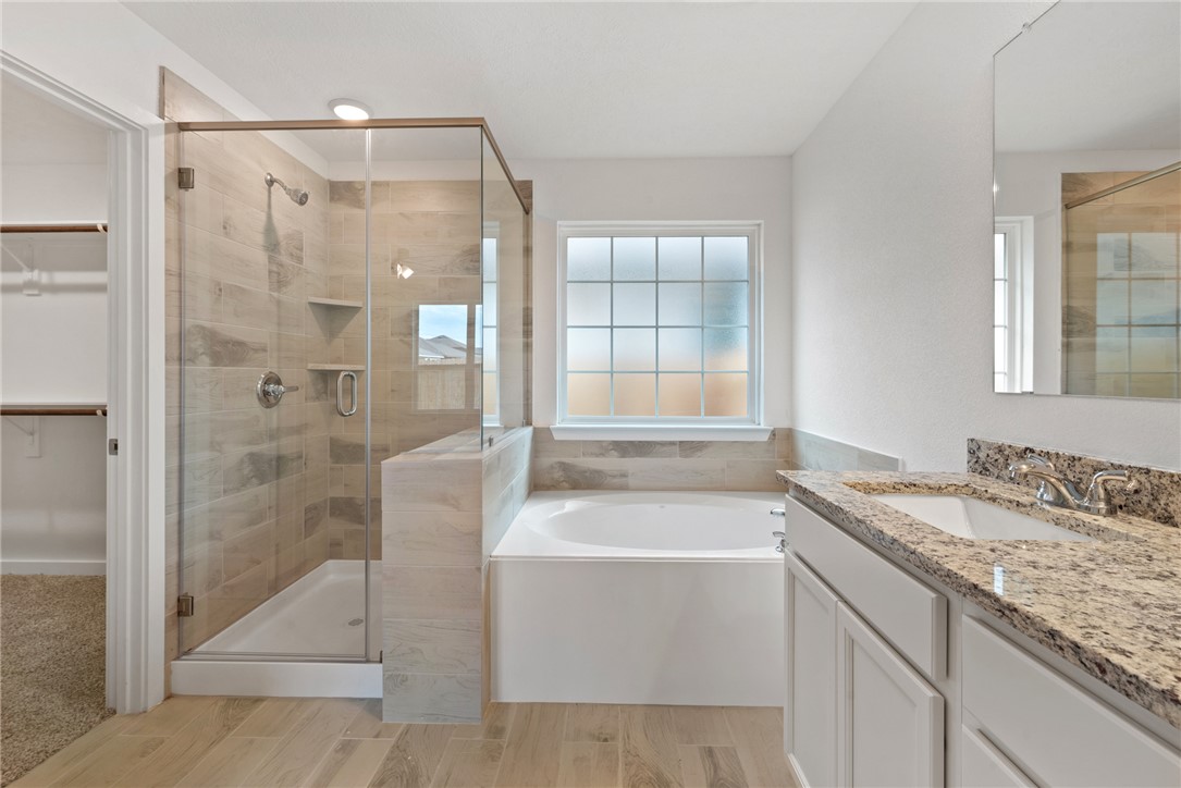2426 Rooke Road Bryan, TX 77807 - Photo 35 of 39 a bathroom with a granite countertop bathtub shower sink and mirror