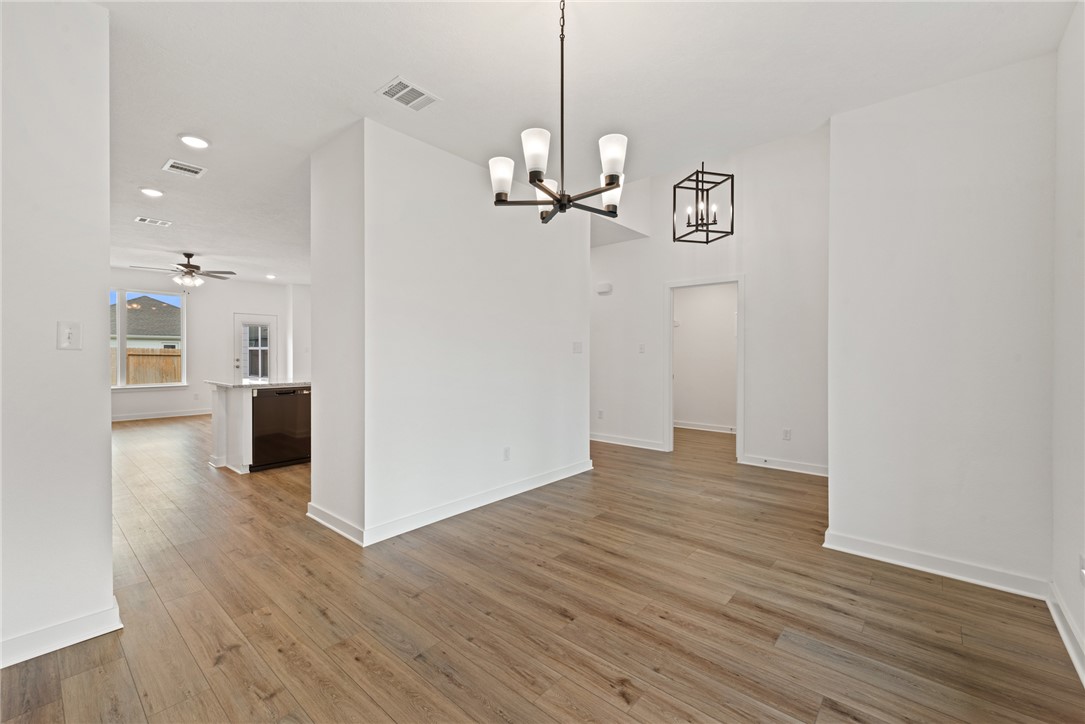2426 Rooke Road Bryan, TX 77807 - Photo 7 of 39 a view of a room with wooden floor staircase and kitchen view