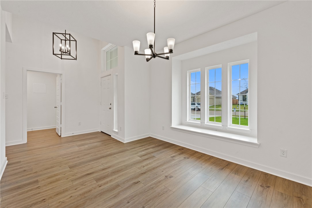 2426 Rooke Road Bryan, TX 77807 - Photo 8 of 39 a view of an empty room with a window and wooden floor