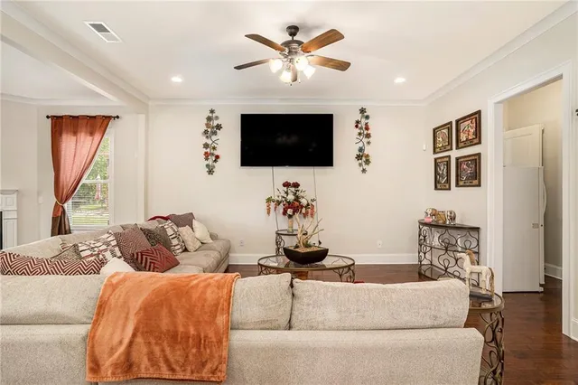 a view of an empty room with wooden floor fireplace and a window