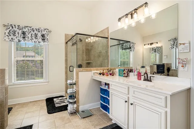 a white bath tub sitting in a bathroom next to a window