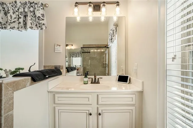 a bedroom with a bed and dresser with mirror