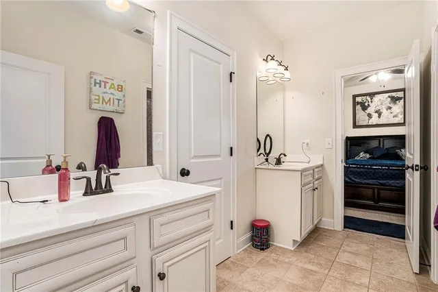 a bedroom with a bed and dresser with mirror