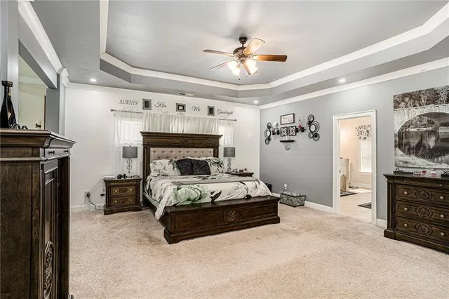 a spacious bedroom with a bed and a chandelier
