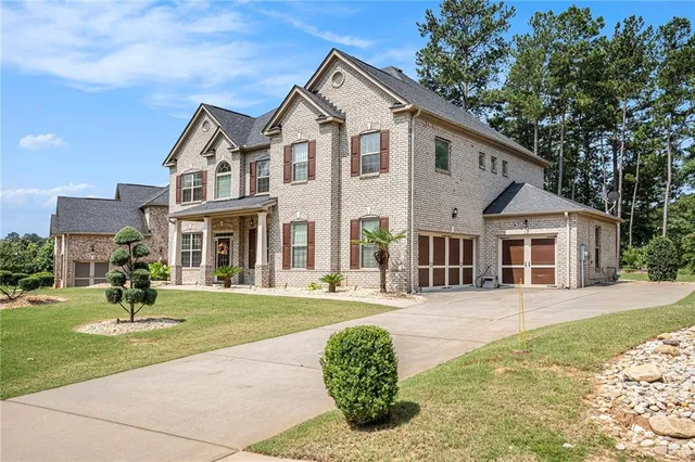 a front view of a house with a yard