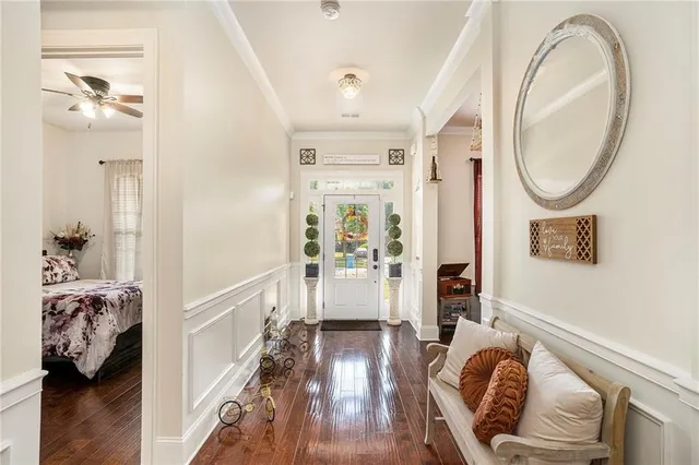 a living room with furniture a flat screen tv and a window