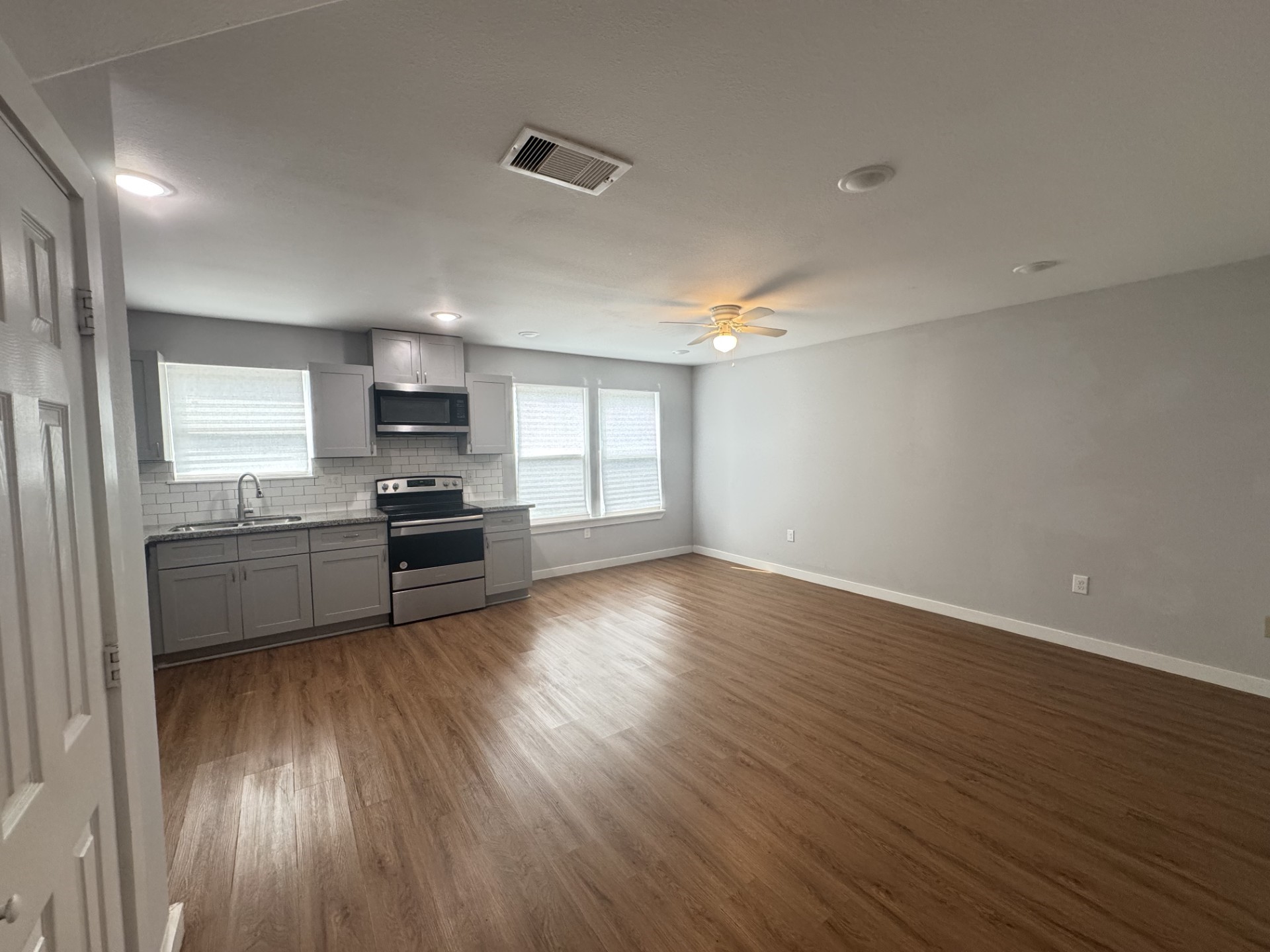 6606 Haight Street Houston, TX 77028 - Photo 13 of 23 a kitchen with stainless steel appliances a refrigerator and a stove top oven