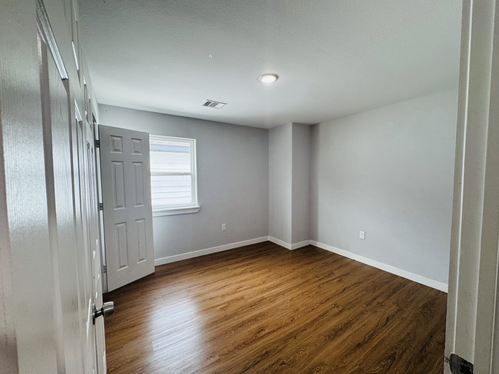 6606 Haight Street Houston, TX 77028 - Photo 19 of 23 an empty room with wooden floor and windows