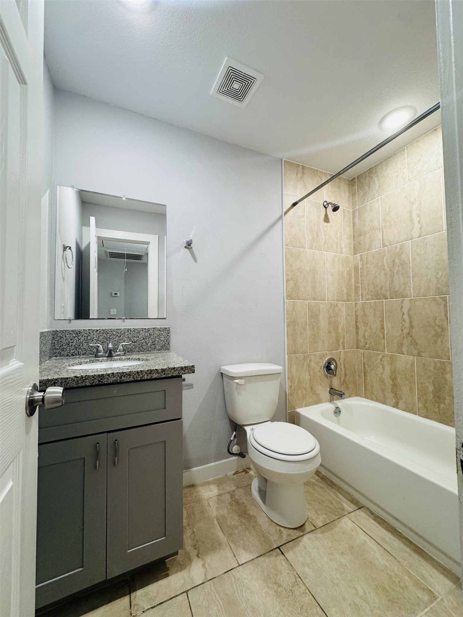 6606 Haight Street Houston, TX 77028 - Photo 20 of 23 a bathroom with a granite countertop toilet a sink and a mirror