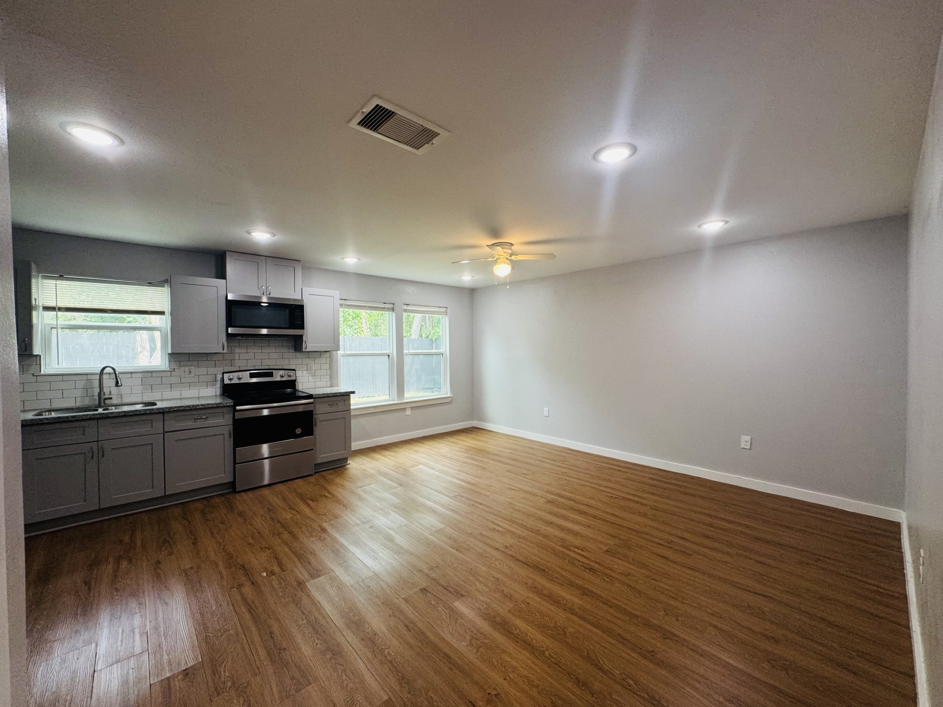 6606 Haight Street Houston, TX 77028 - Photo 2 of 23 a kitchen with stainless steel appliances granite countertop a stove top oven a sink and a microwave