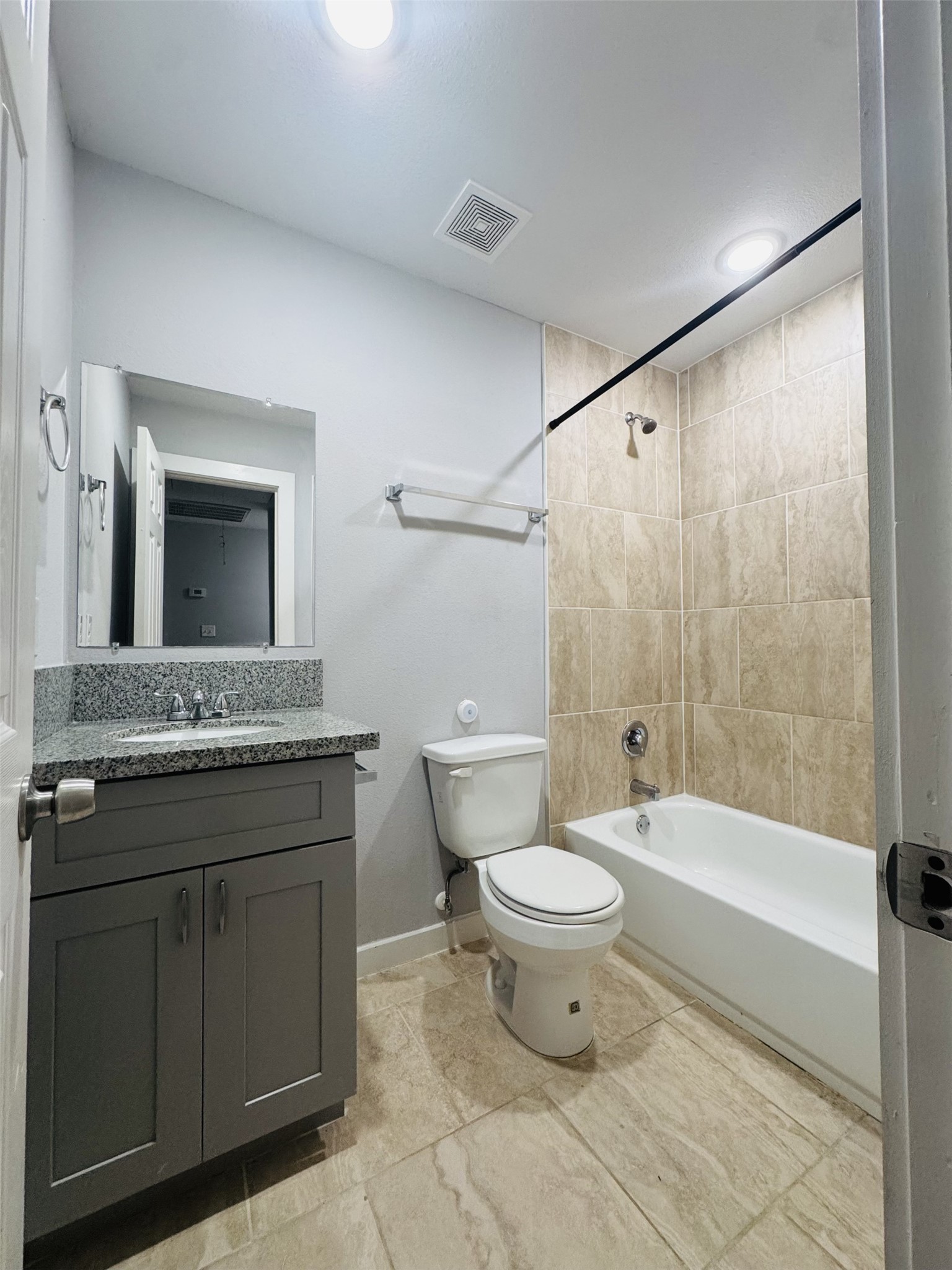 6606 Haight Street Houston, TX 77028 - Photo 10 of 23 a bathroom with a granite countertop toilet a sink and a mirror