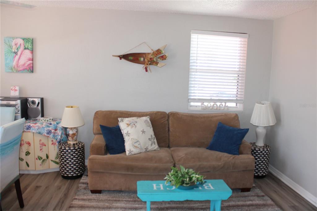 6800 Sunset Way, Unit 1708 St. Pete Beach, FL 33706 - Photo 7 of 15 a living room with furniture and a window