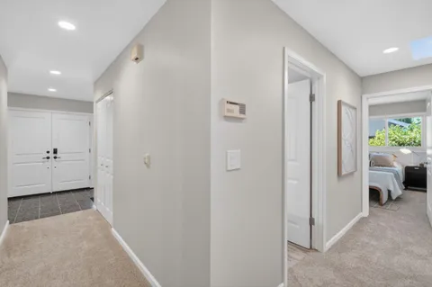 a bedroom with a bed and a painting on the wall