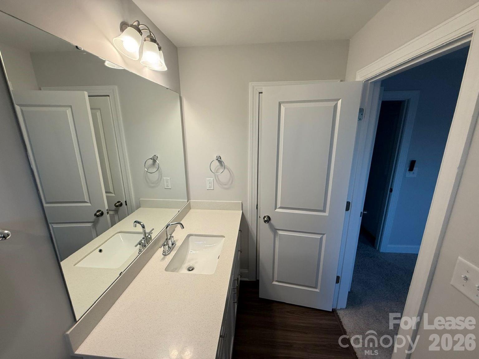 5593 Stafford Road Charlotte, NC 28215 - Photo 12 of 23 a en suite bathroom with a sink a mirror and a shower
