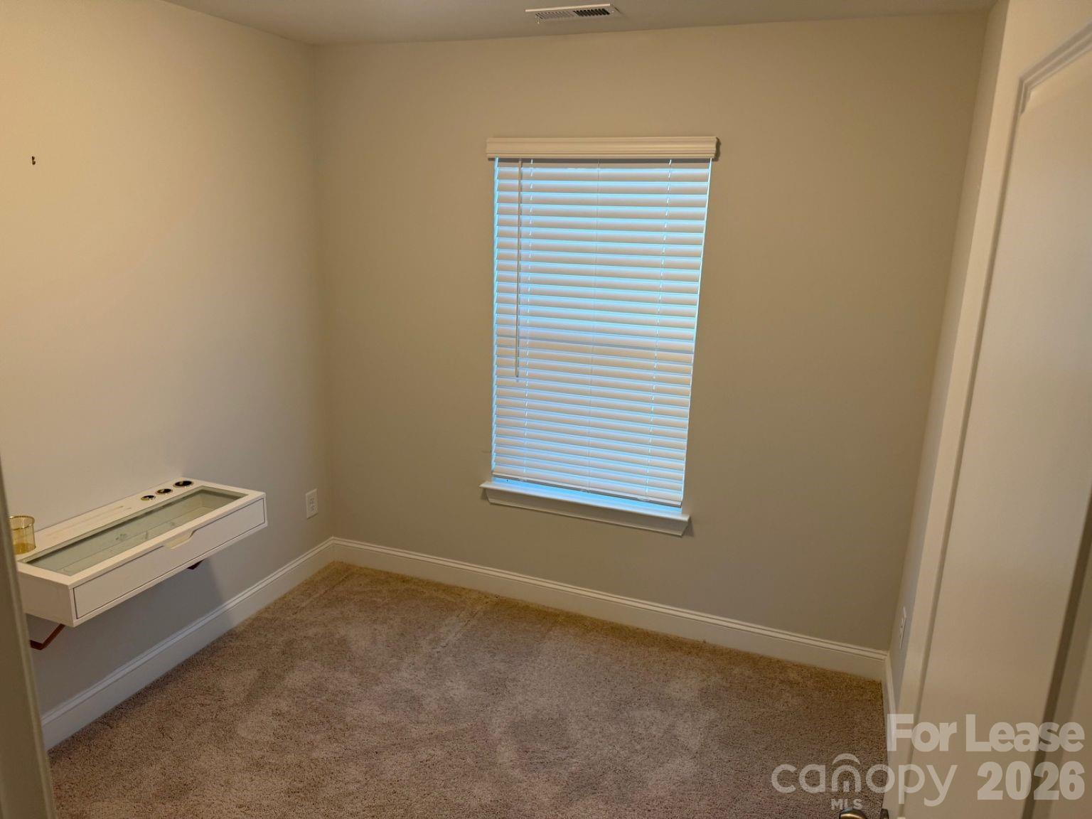 5593 Stafford Road Charlotte, NC 28215 - Photo 14 of 23 a view of an empty room with a window