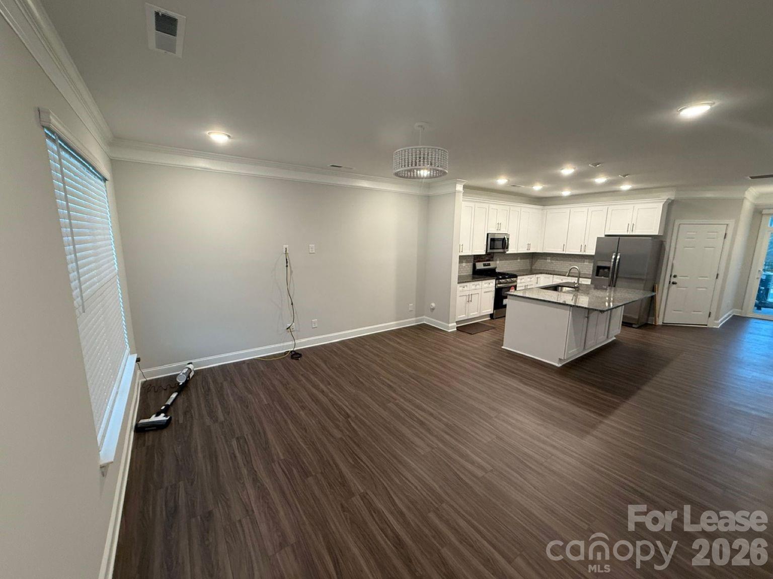 5593 Stafford Road Charlotte, NC 28215 - Photo 4 of 23 a view of kitchen with cabinets and wooden floor