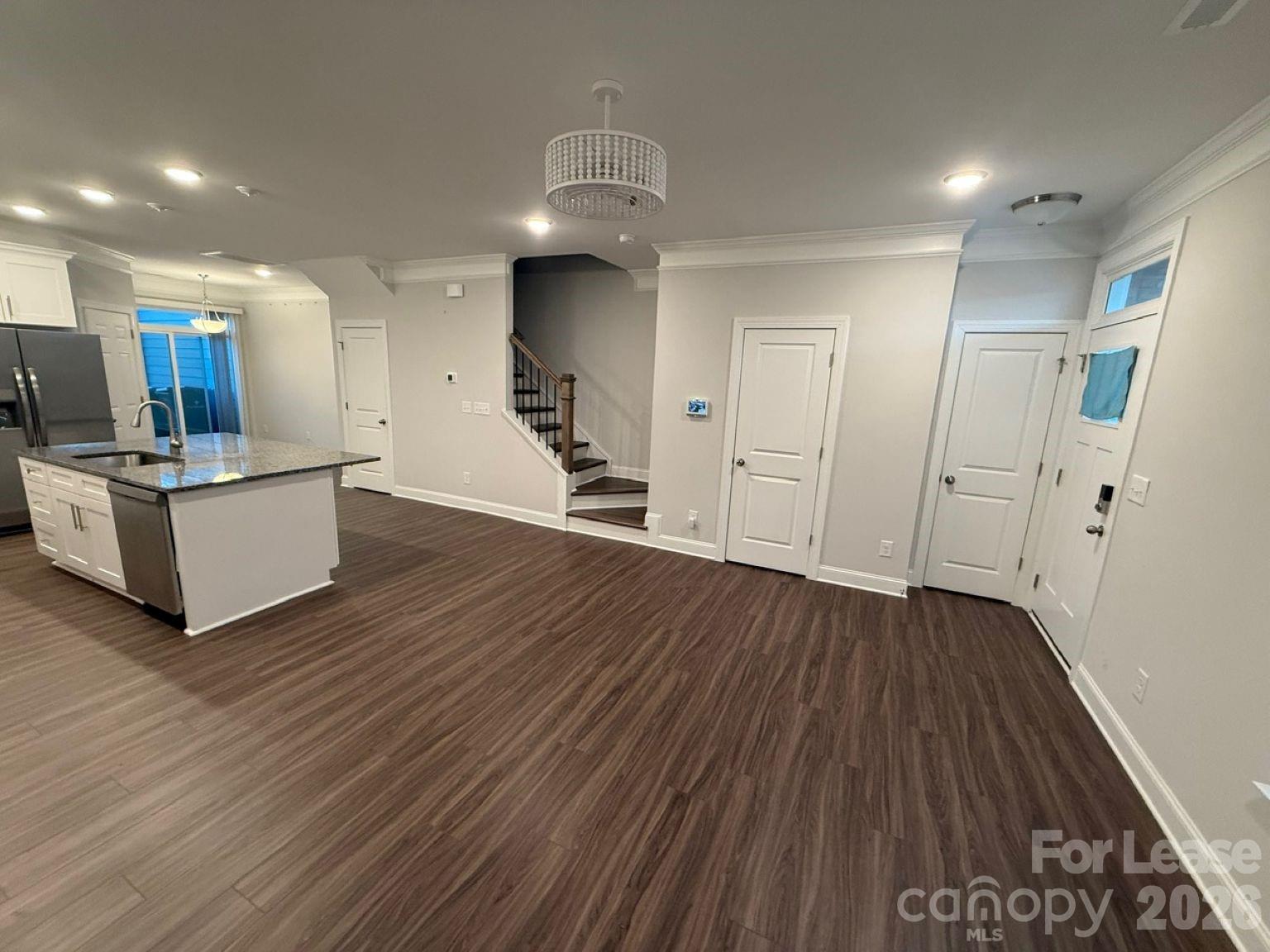 5593 Stafford Road Charlotte, NC 28215 - Photo 6 of 23 a view of a livingroom with wooden floor and staircase