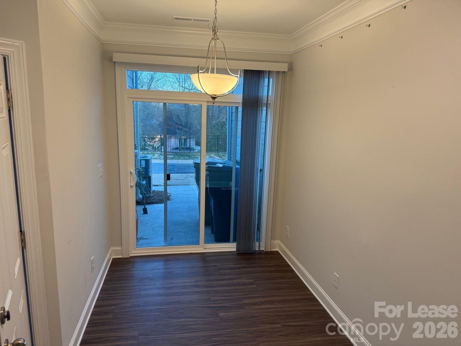 5593 Stafford Road Charlotte, NC 28215 - Photo 7 of 23 a view of a hallway with wooden floor and door
