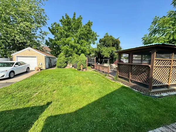 an outdoor view of house with backyard and swimming pool