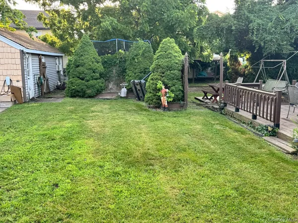 a front view of a house with a garden and parking