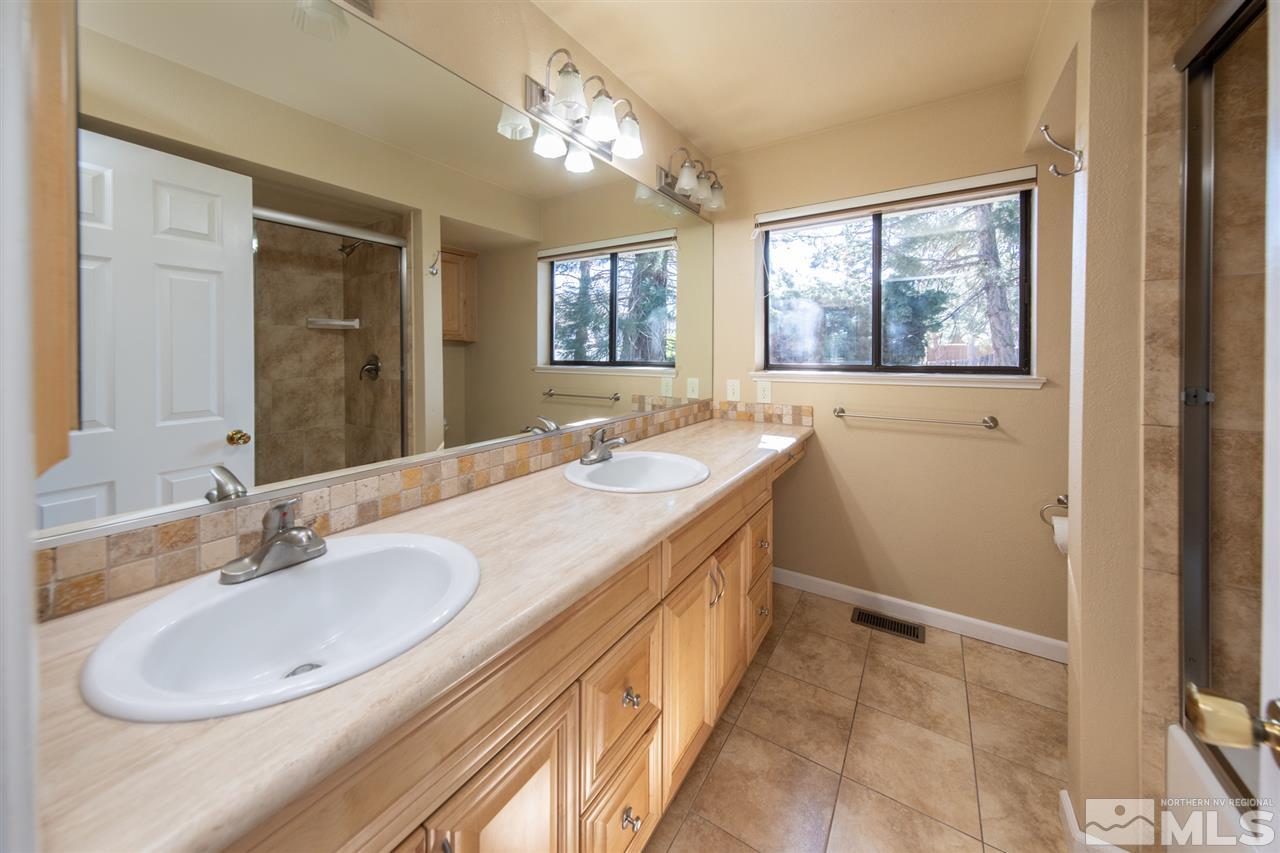 13100 Fellowship Way Reno, NV 89511 - Photo 21 of 40 a bathroom with a sink a tub and a mirror