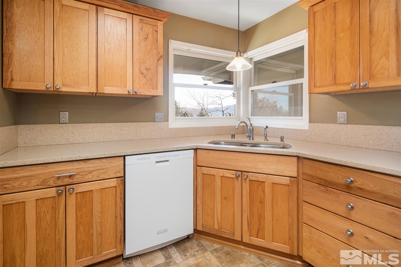 13100 Fellowship Way Reno, NV 89511 - Photo 9 of 40 a kitchen with granite countertop white cabinets and white appliances