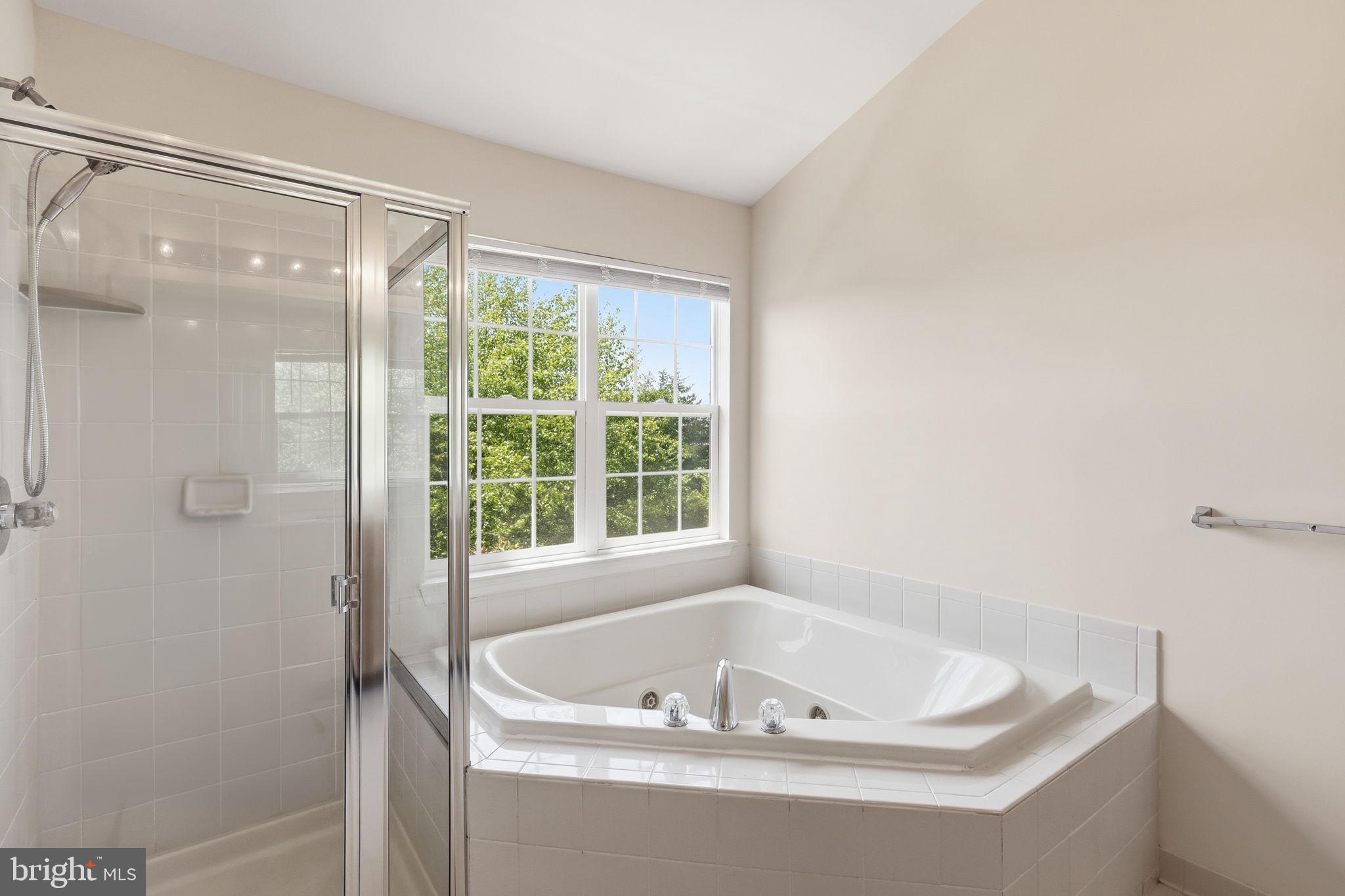 19617 Edgemont Square Ashburn, VA 20147 - Photo 29 of 65 a bathroom with a tub and shower