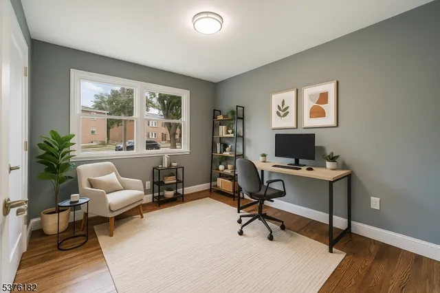 a view of a livingroom with workspace and a window