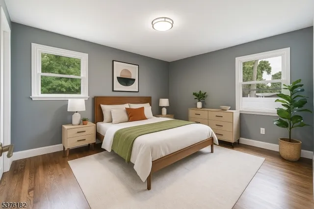 a bedroom with a bed and a potted plant
