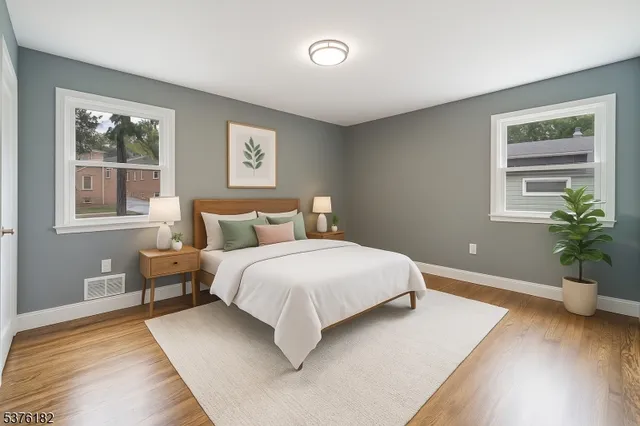 a bedroom with a large bed and a potted plant