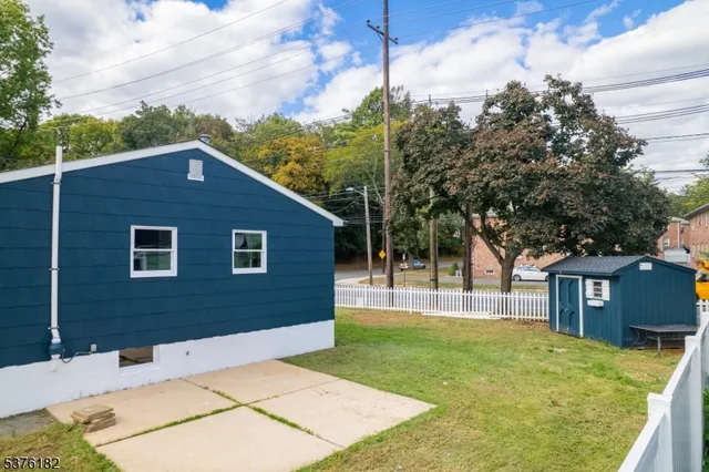a backyard of a house with table and chairs