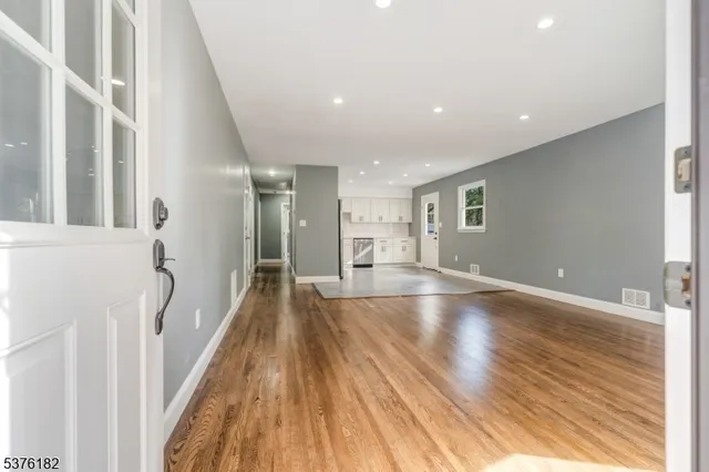 a view of a room with wooden floor and staircase