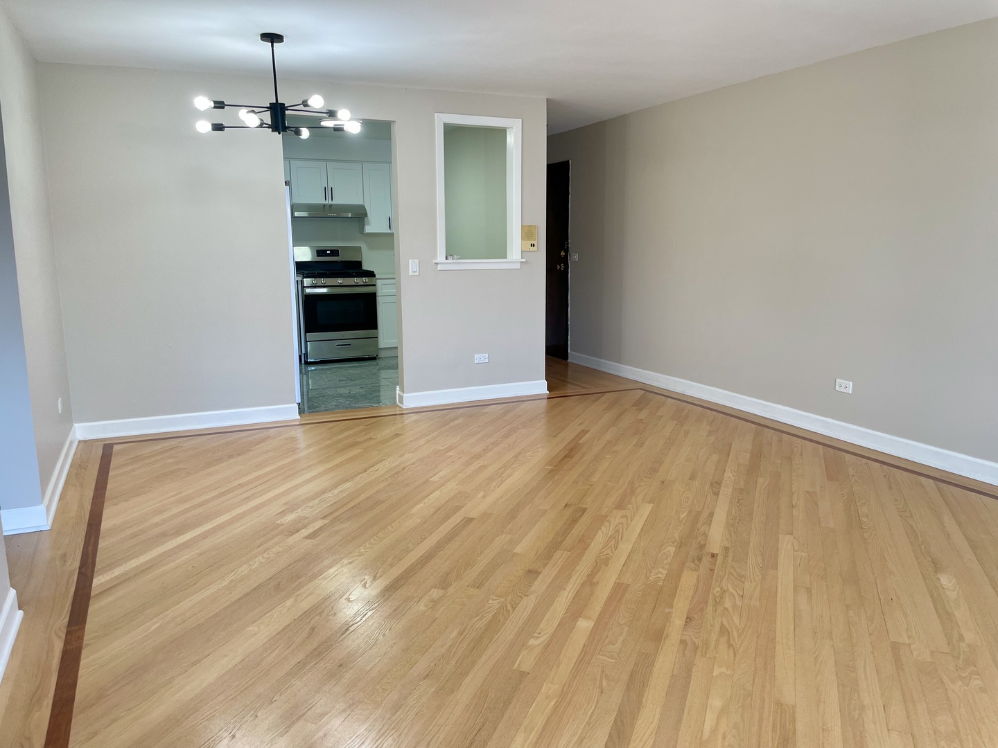1258 Brown Street, Unit 302 Des Plaines, IL 60016 - Photo 3 of 17 a view of empty room with wooden floor