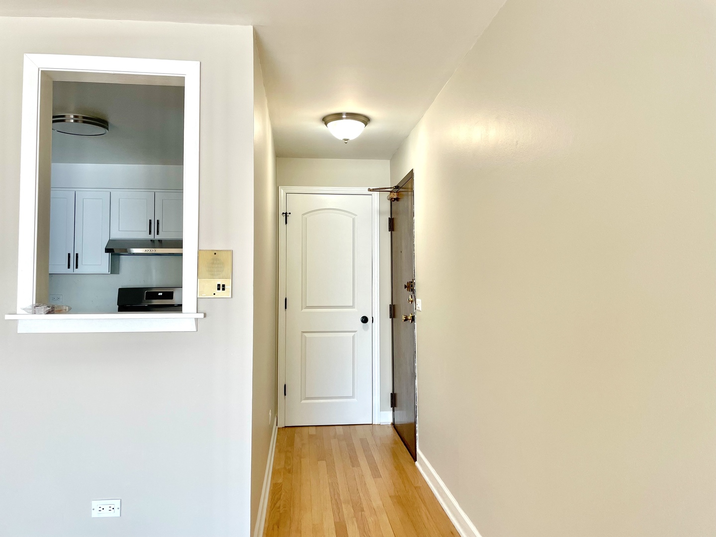 1258 Brown Street, Unit 302 Des Plaines, IL 60016 - Photo 4 of 17 a view of a hallway with wooden floor