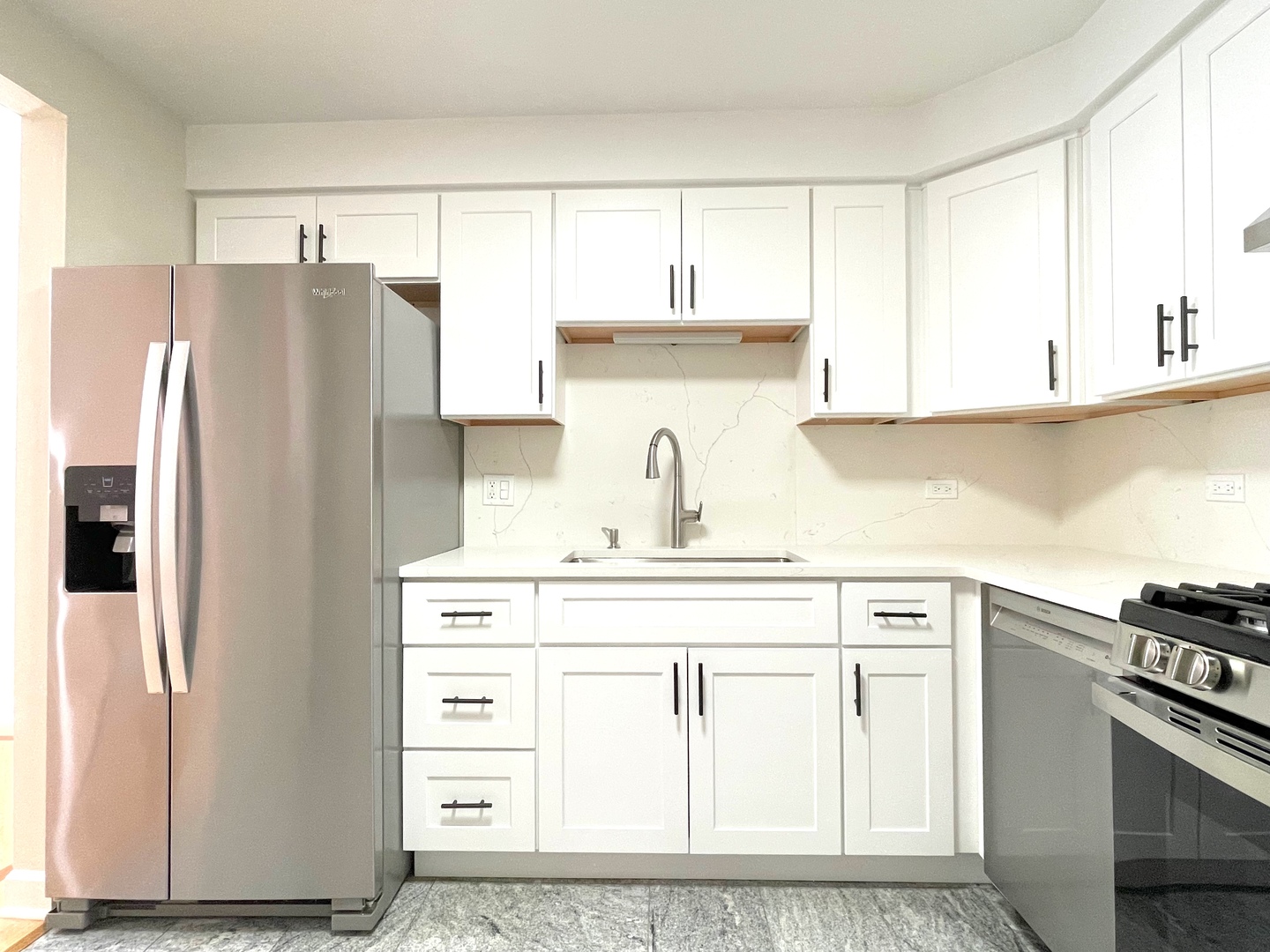 1258 Brown Street, Unit 302 Des Plaines, IL 60016 - Photo 6 of 17 a kitchen with granite countertop a refrigerator sink and cabinets