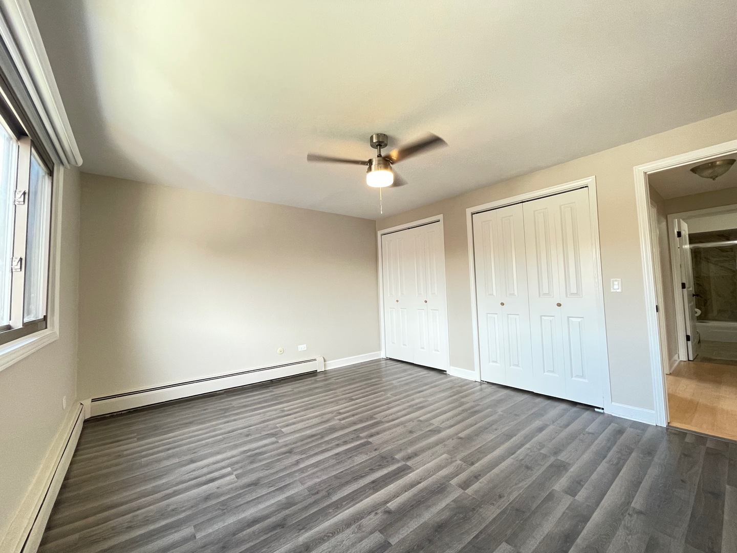 1258 Brown Street, Unit 302 Des Plaines, IL 60016 - Photo 7 of 17 an empty room with wooden floor and windows