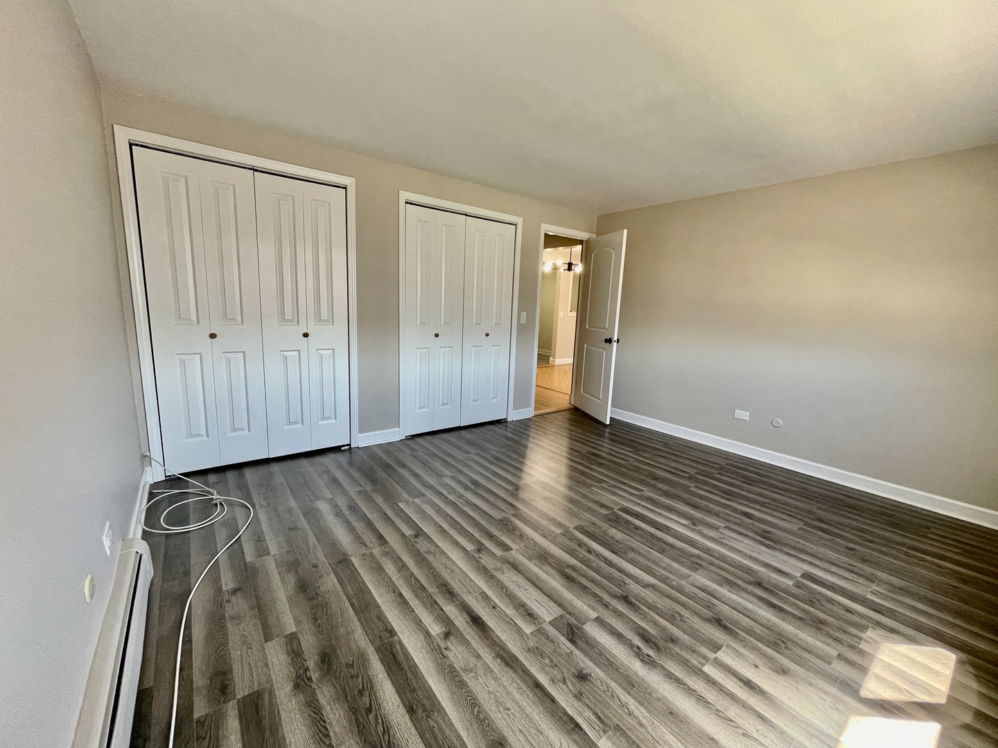 1258 Brown Street, Unit 302 Des Plaines, IL 60016 - Photo 8 of 17 a view of an empty room with wooden floor