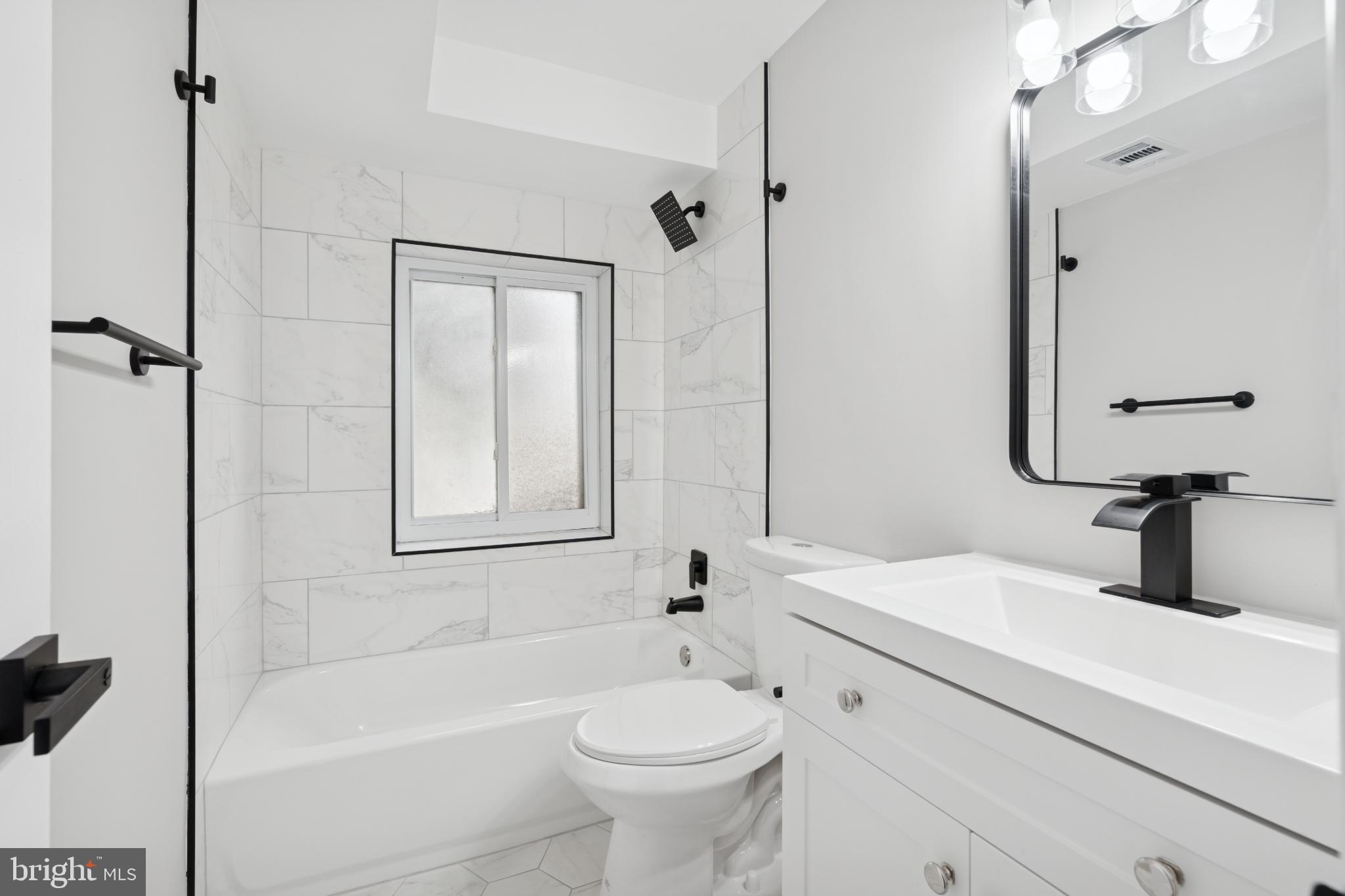 11909 Tarragon Road, Unit D Reisterstown, MD 21136 - Photo 8 of 14 Sleek modern bathroom with elegant finishes.