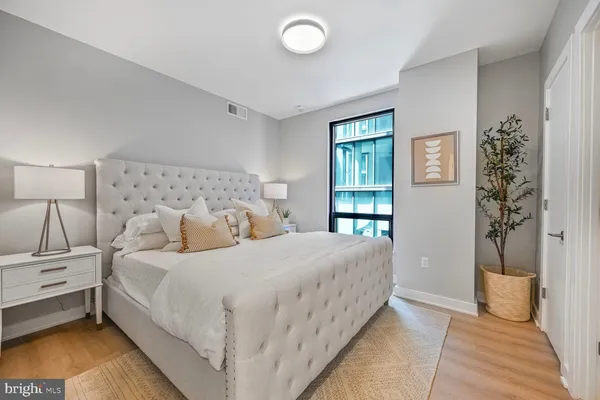 a bathroom with a granite countertop sink a potted plant and a window