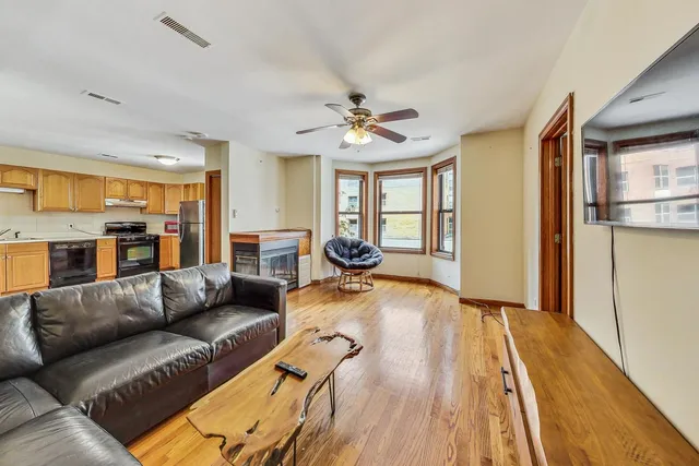a living room with furniture and a chandelier
