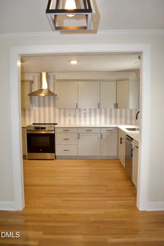 a kitchen with a sink stove and cabinets