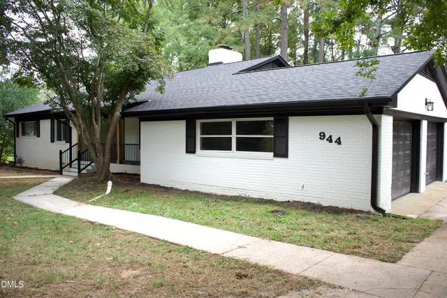 a house that has a tree in front of it