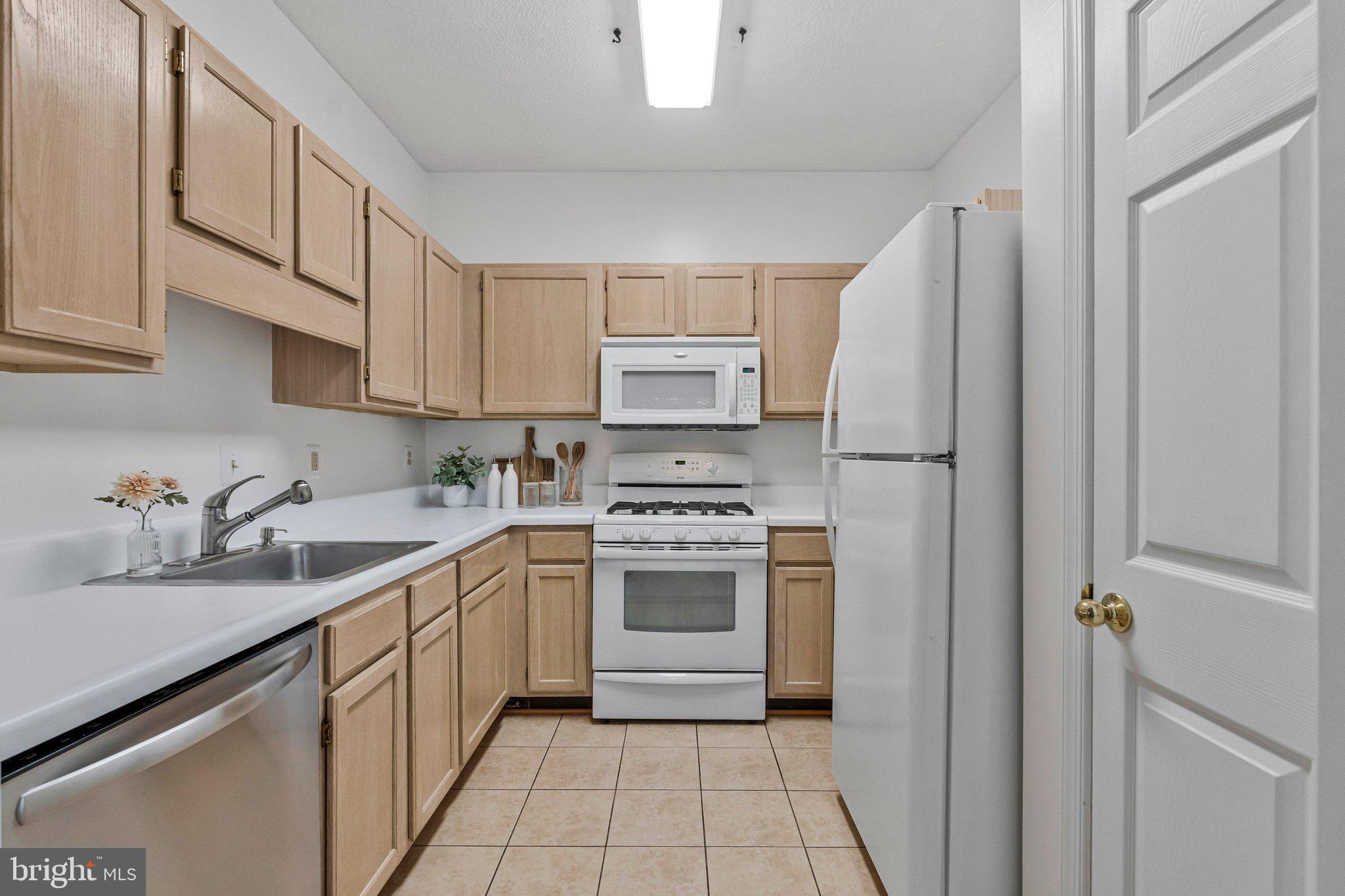 1720 Lake Shore Crest Drive, Unit 26 Reston, VA 20190 - Photo 11 of 38 a kitchen with stainless steel appliances granite countertop a sink stove and refrigerator