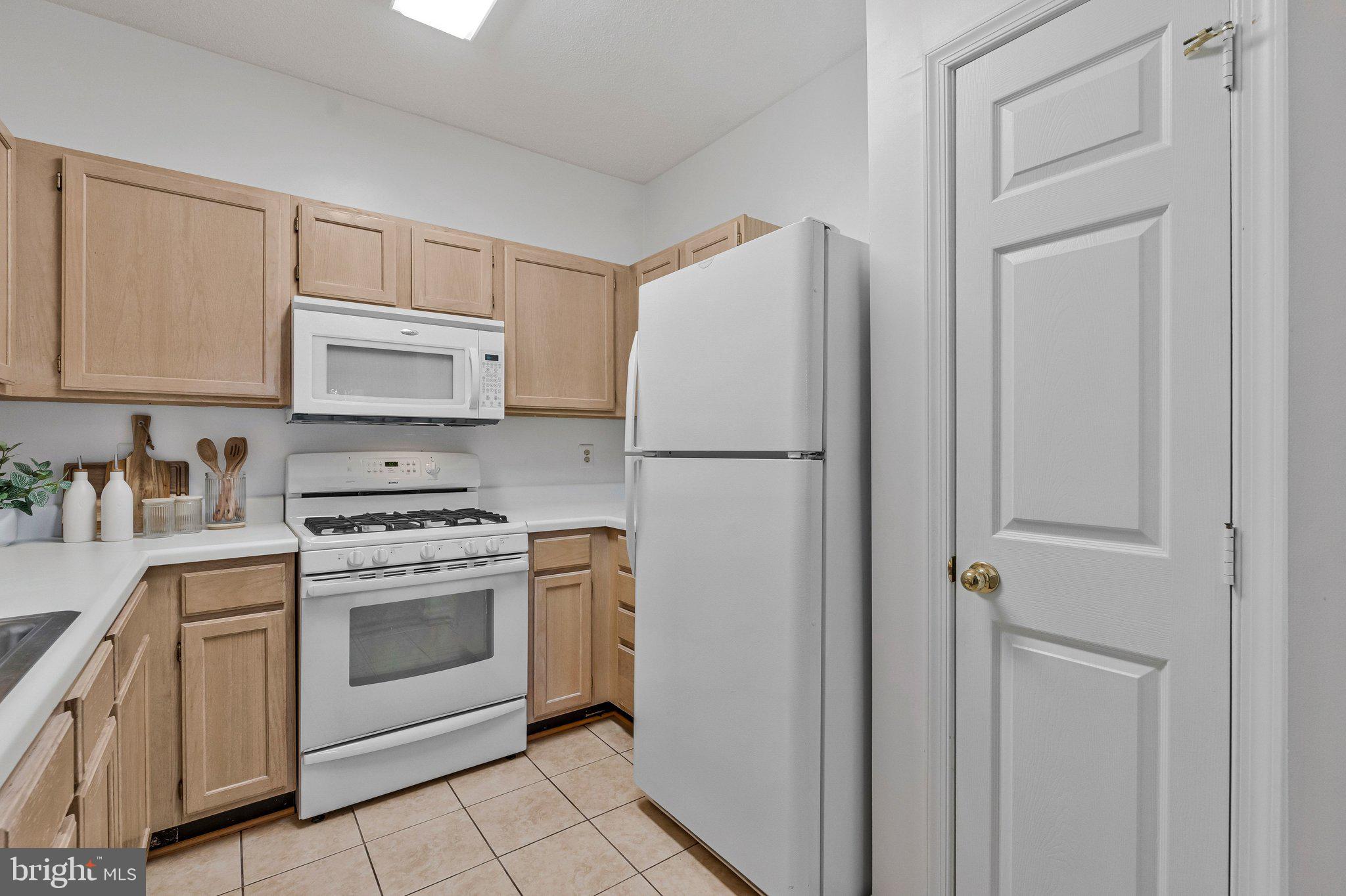 1720 Lake Shore Crest Drive, Unit 26 Reston, VA 20190 - Photo 12 of 38 a kitchen with cabinets stainless steel appliances and a sink
