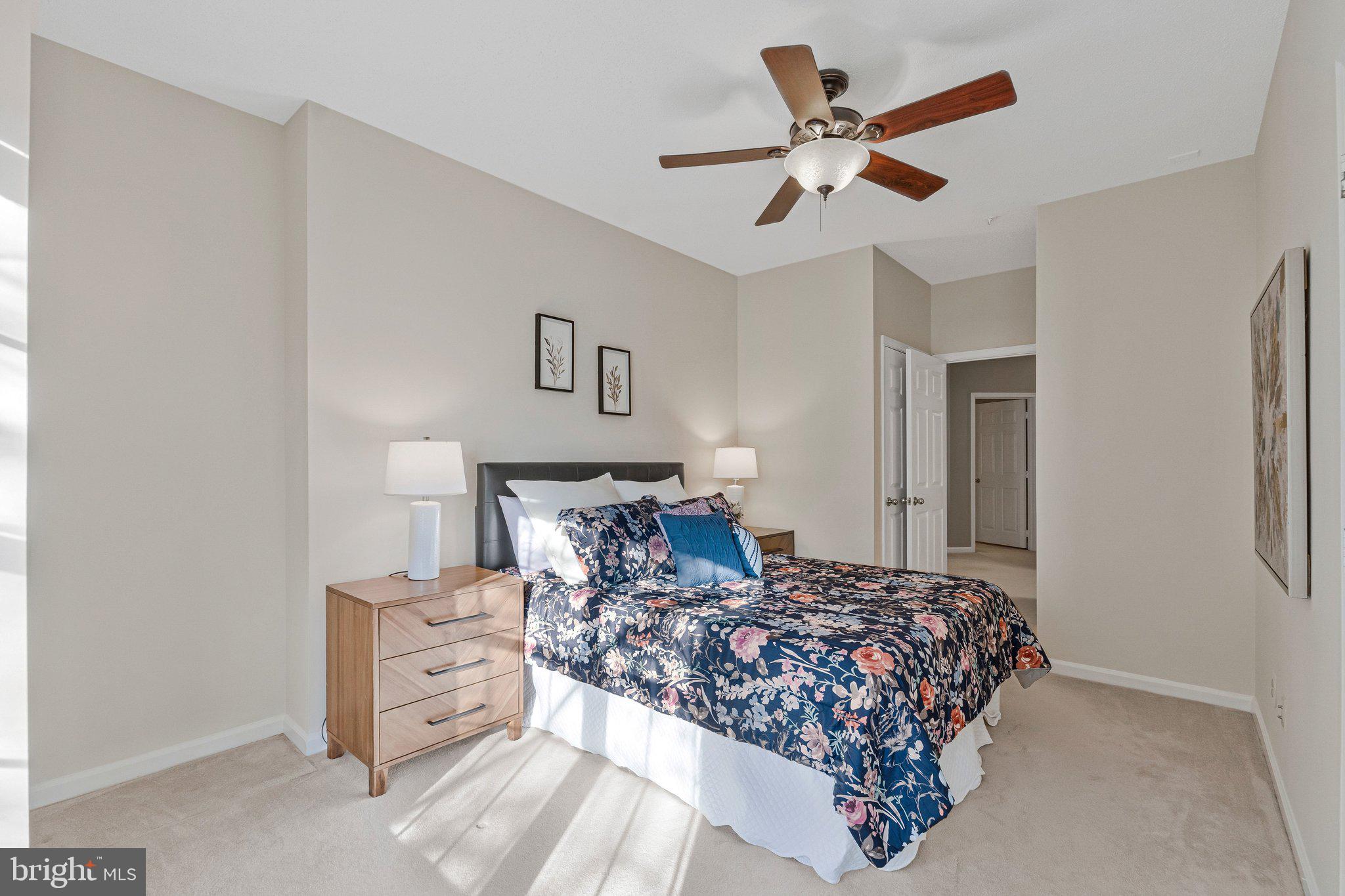 1720 Lake Shore Crest Drive, Unit 26 Reston, VA 20190 - Photo 14 of 38 a bedroom with a large bed and a ceiling fan
